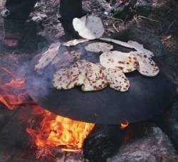 pitta on metal dome over fire